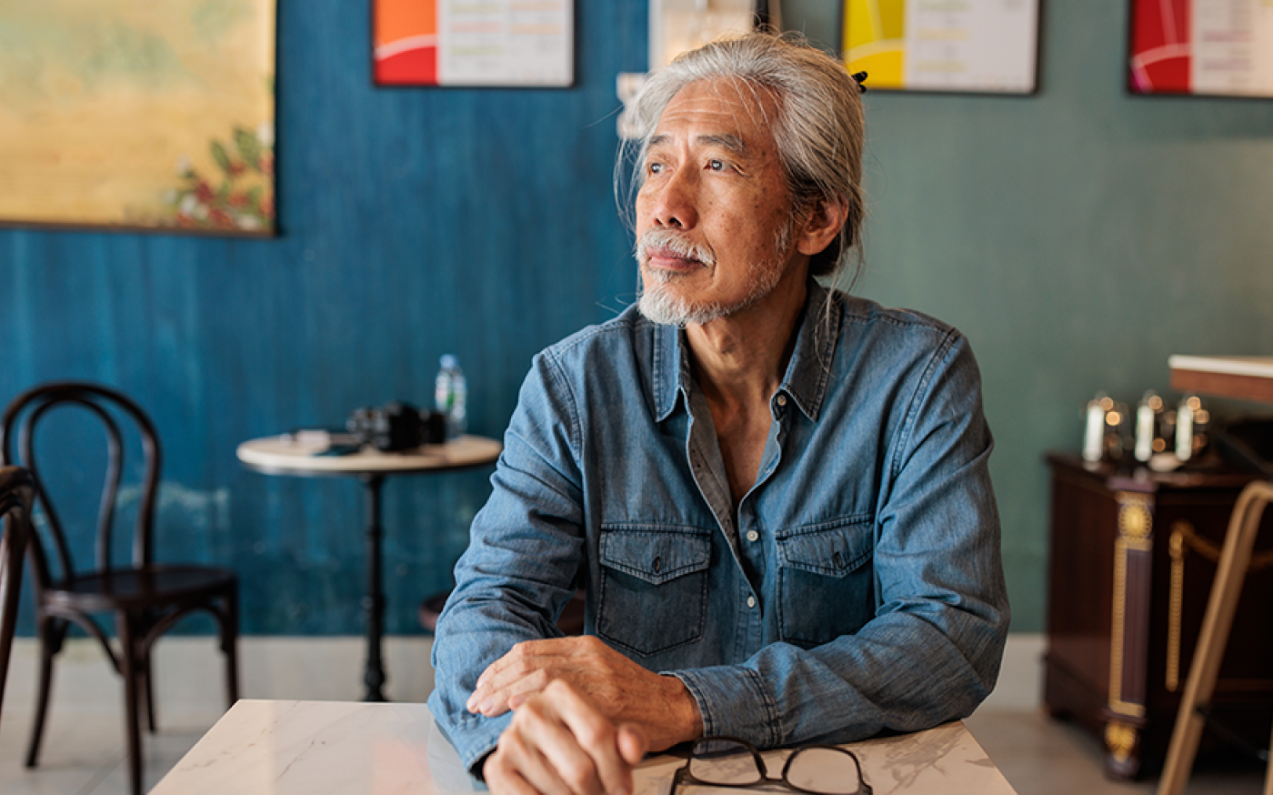 Person sitting at a table pondering their thoughts
